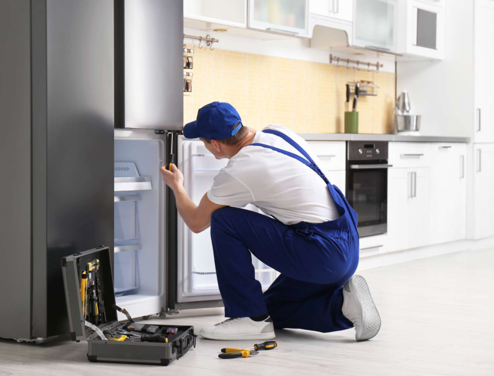 A picture of a technician fixing the refrigerator 